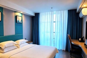 A hotel room with a bed, a desk, an air conditioner, and a window with curtains. - Tiandi Dasha Hotel (Khorgas)