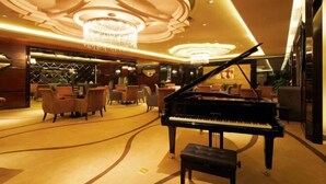 A grand lobby with a grand piano, elegant chandeliers, and plush seating areas. - Rich Global Hotel (Li County)