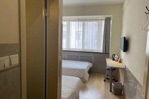 A hotel room with two single beds, a small desk with a chair, a television mounted on the wall, and a window with curtains. - Fanke Hotel (Jinan Railway Station South Square Branch ) (Jinan)