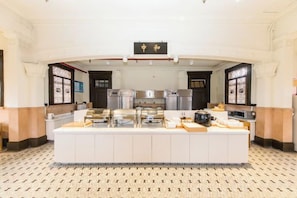 A buffet setup with a central island, multiple serving stations, and a sign above indicating the section. - JI Hotel (Shanghai The Bund Ningbo Road) (Shanghai)