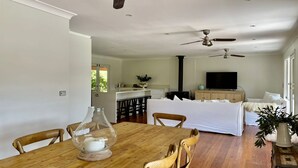 A spacious living area with a dining table, chairs, a sofa, and a TV. - Kurraba - Family friendly country escape with pool (Kangaroo Valley)