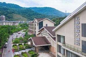 A building with a sign indicating it is a hotel. There are multiple floors, and the architecture includes a mix of modern and traditional styles. - Wufeng International Hotel (Wufeng)