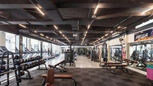 A gym with treadmills, weight machines, and benches. - Wufeng International Hotel (Wufeng)