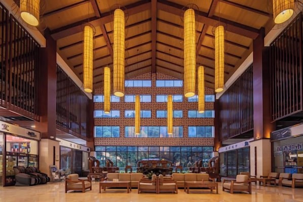 A spacious lobby with high ceilings, large windows, and modern lighting fixtures. - Wufeng International Hotel (Wufeng)