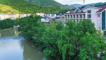 A riverside hotel with multiple buildings, a lock system, and lush greenery.