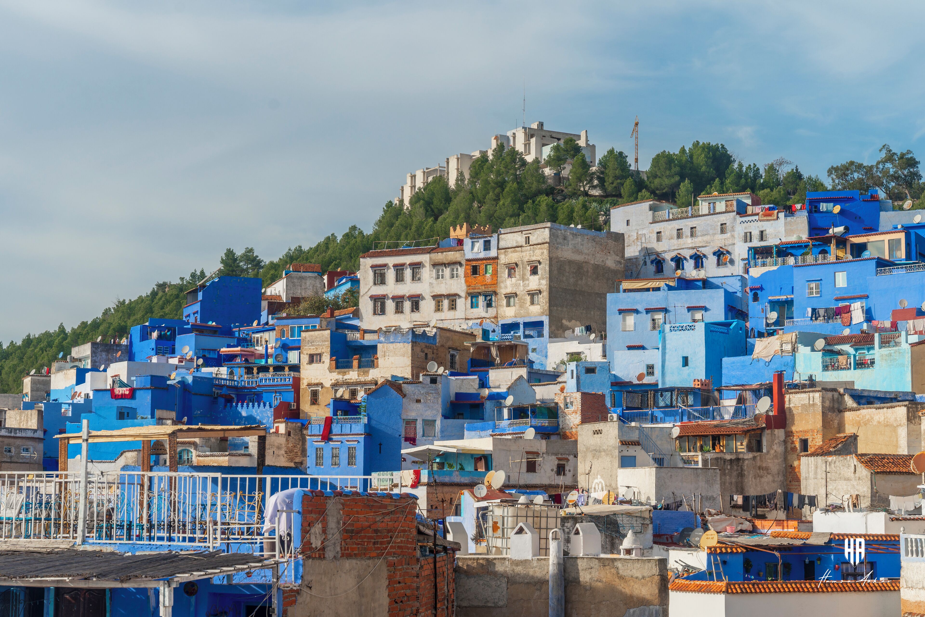 A densely packed urban area with a variety of building structures, some with visible satellite dishes and antennas.