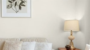 A living room with a sofa, a side table with a lamp, and a framed artwork on the wall. - Classy Home Near Beach & Airport

 (Hagersville)