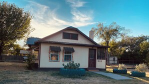 A single-story house with a gabled roof, a front door, and a number '616' on the side. - Charming 2-bedroom house in Coleman with AC and WiFi.  Sleeps 6 & no pets. (Coleman)