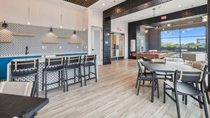 A modern indoor space with a pool table, bar area, and seating. - The Sound Wave Luxury Condo Near Vanderbilt on Music Row, Just Minutes to Broadway (Nashville)