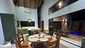 A modern kitchen with a dining area.