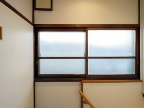 Enjoy the traditional design and natural light pouring in through the window with a wooden-framed view.
