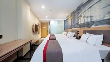 A hotel room with a large bed, a desk, and a painting on the wall.