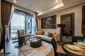 Deluxe Double Room, 2 Bedrooms | Living area | 65-inch flat-screen TV with satellite channels, Netflix - Lumiere riverside - Apartment Raymond Holm (Ho Chi Minh City)
