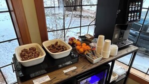 A buffet area with various food options like chicken sausage, banana walnut chocolate chip muffins, and oranges. - Donner Lake Inn (Truckee)