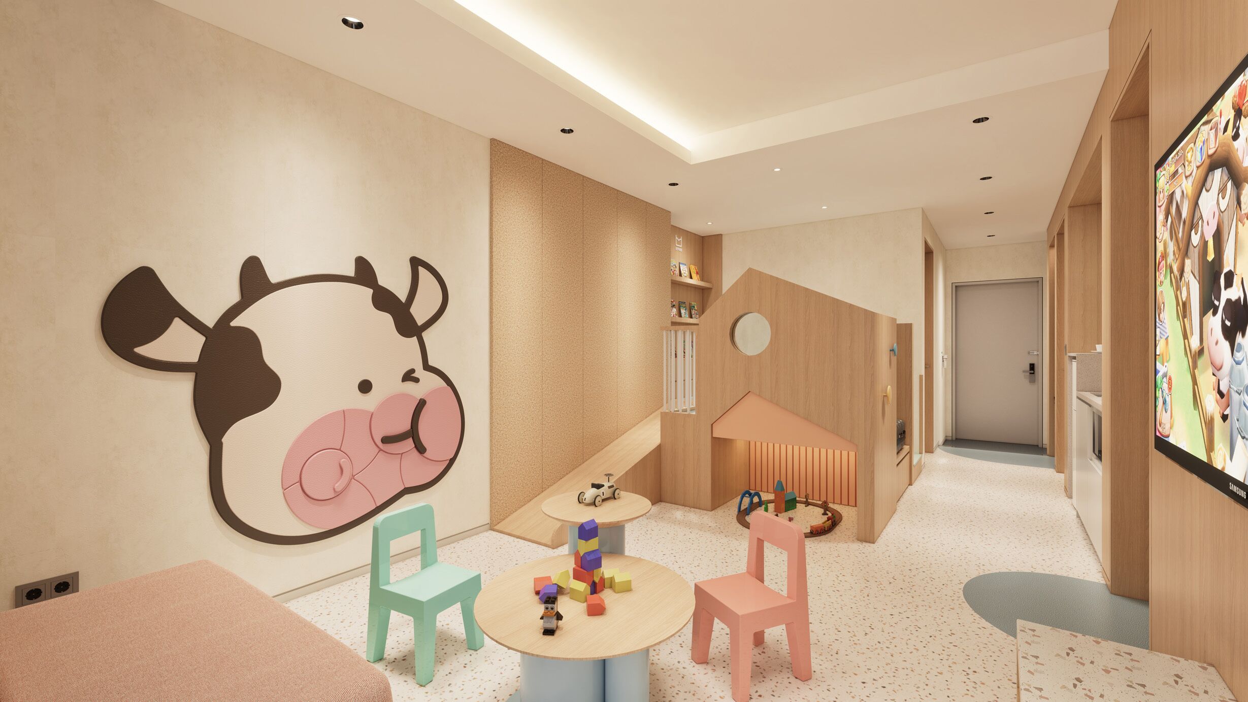 A children's play area with a large wall mural, a small table with toys, and two chairs.
