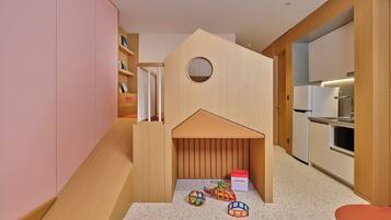 A modern kitchen with wooden cabinets, a built-in oven, and a refrigerator.