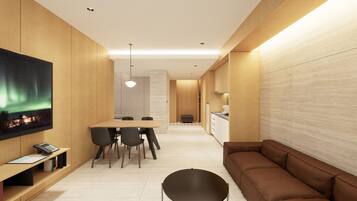 A modern kitchen with wooden cabinets, a dining area with a table and chairs, and a sofa.