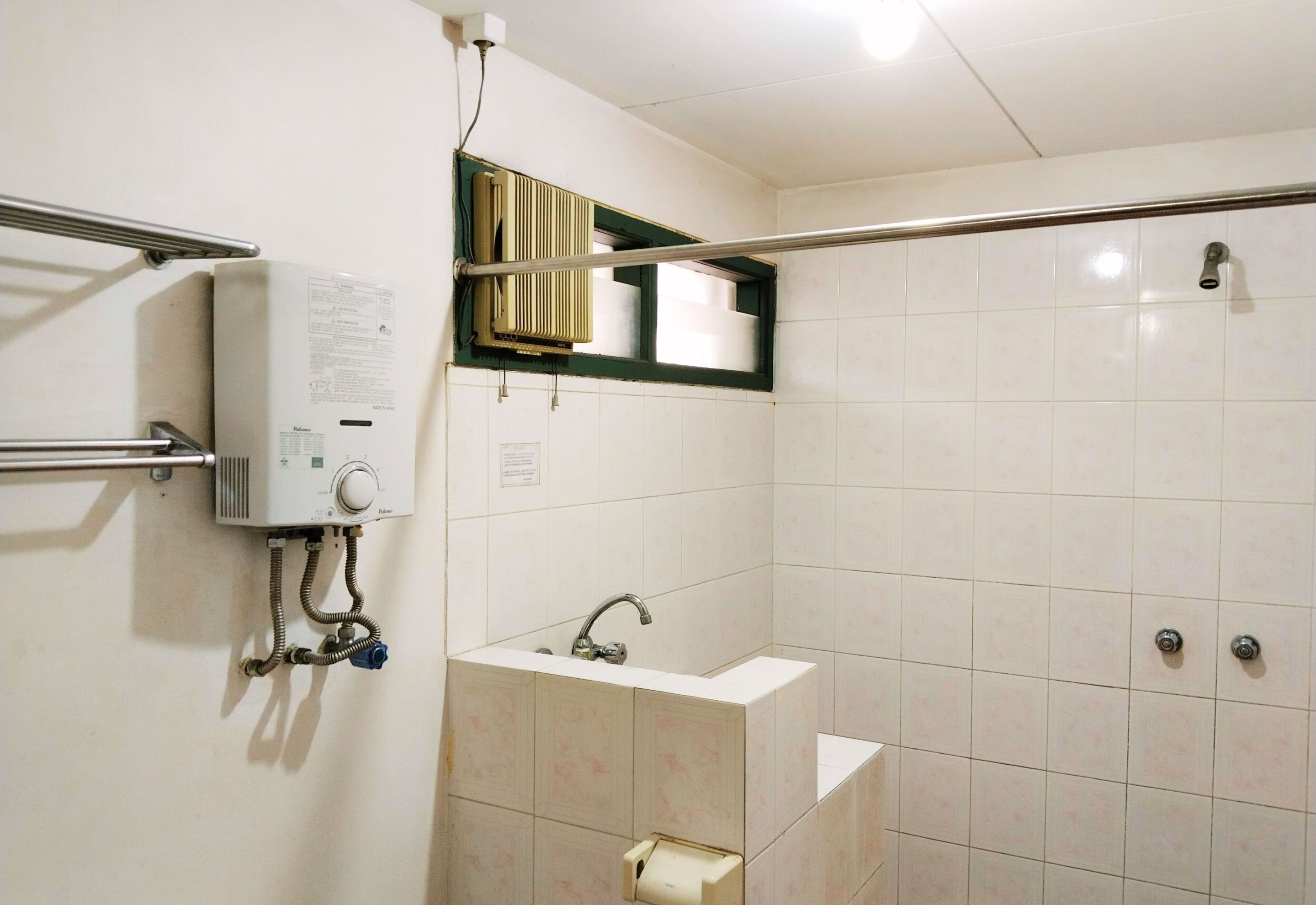 A bathroom with a shower, a sink, and a toilet.