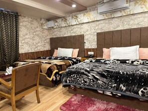 A hotel room with two beds, a wooden chair, a desk, and a fluffy rug. - Hotel Golden Palm By Rattans By GRB (Srinagar)
