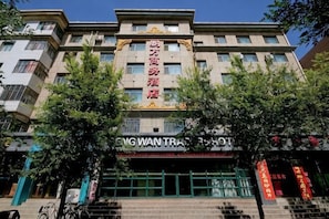 A multi-story building with a prominent sign in the center.