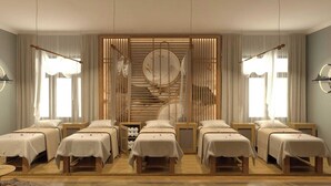 A hotel room with six beds arranged in two rows, a central spiral staircase, and a large window with curtains. - YO Hotel (Hai Phong)
