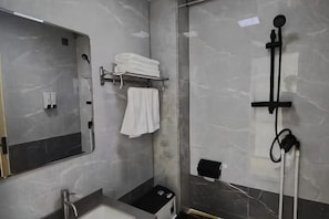 A bathroom with a mirror, towel rack, shower, and a sink. - Duolun Huidu Hotel (Duolun)