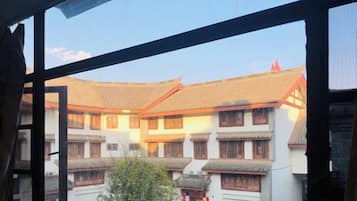 A traditional building with multiple windows and a courtyard.