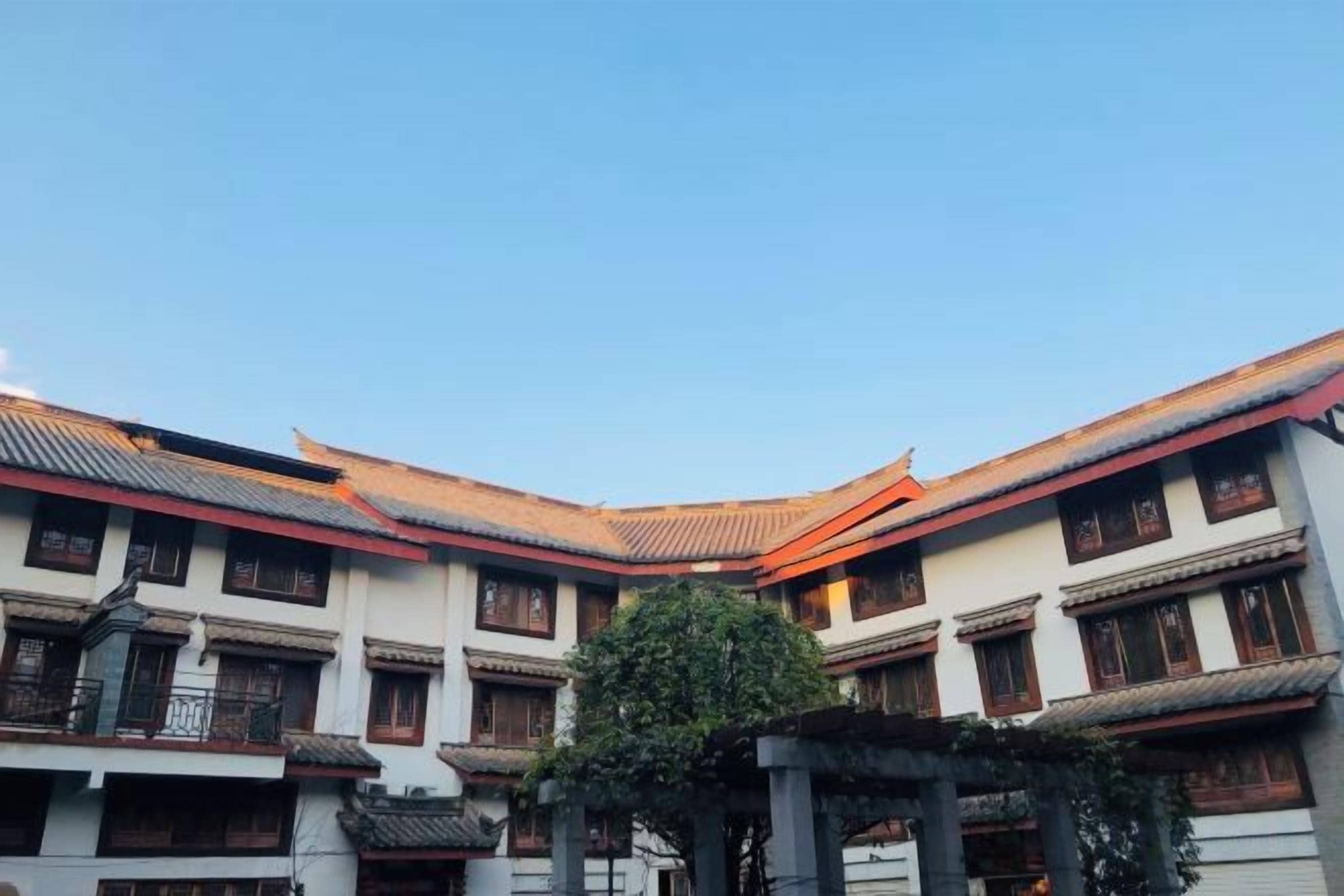 A traditional building with multiple levels, a curved roof, and a central courtyard.