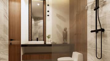 Un baño moderno con tocador de madera, inodoro blanco y ducha con cabezal negro.