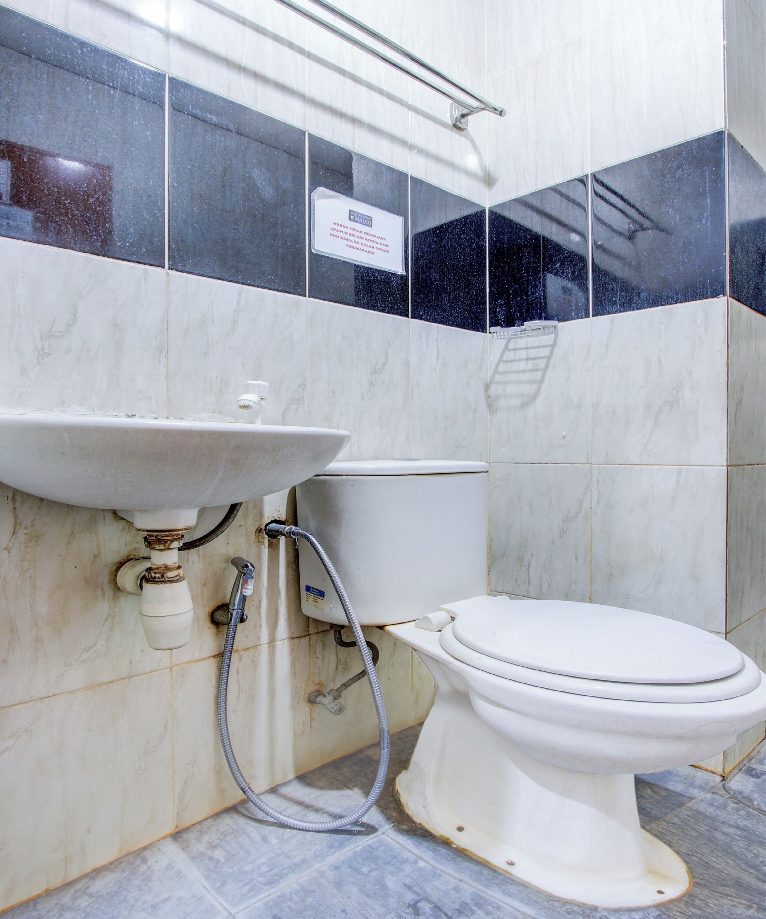 A bathroom with a white sink, toilet, and shower.