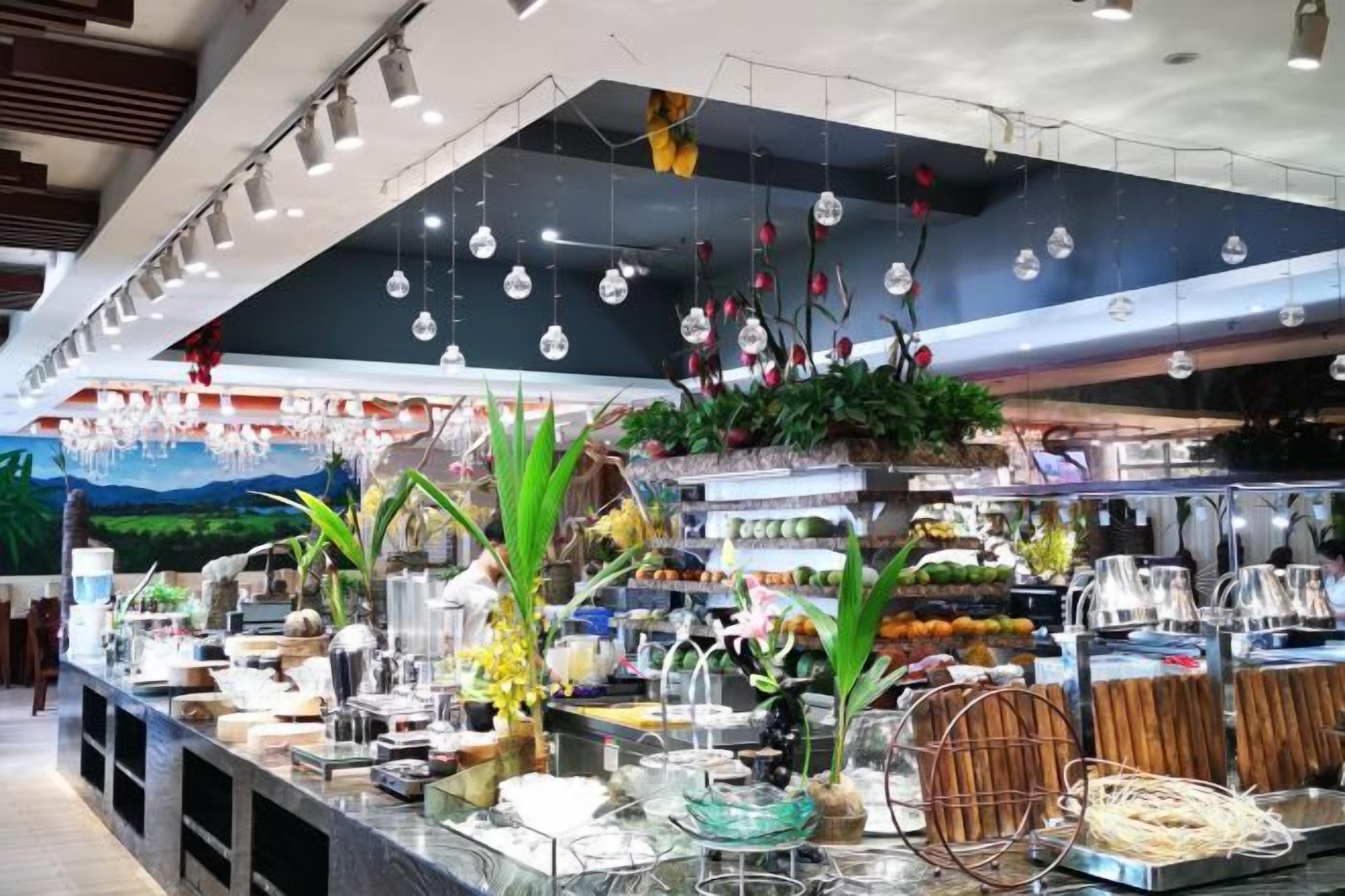 A well-lit indoor space with a variety of items on display, including glassware and decorative plants.
