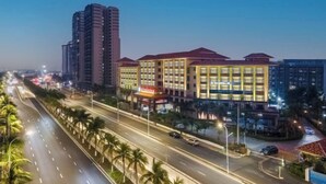 A multi-story hotel with a modern design, featuring a prominent entrance and a well-lit facade. - Real Madrid Holiday Island Style Hotel (Haikou Qilou Old Street) (Haikou)