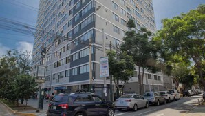A multi-story hotel with a modern design, featuring a mix of glass and concrete facades. - w* | Divine 2BR with Majestic Deco in Barranco (Barranco)
