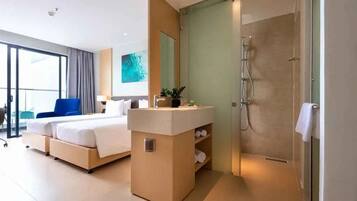 A modern hotel room with a large bed, a bedside table with a mirror, a shower area, and a balcony with a chair.