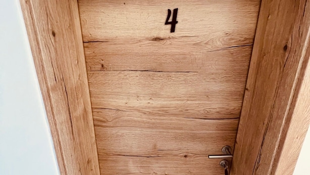 A wooden door with the number 4, a keyhole, and a door handle.