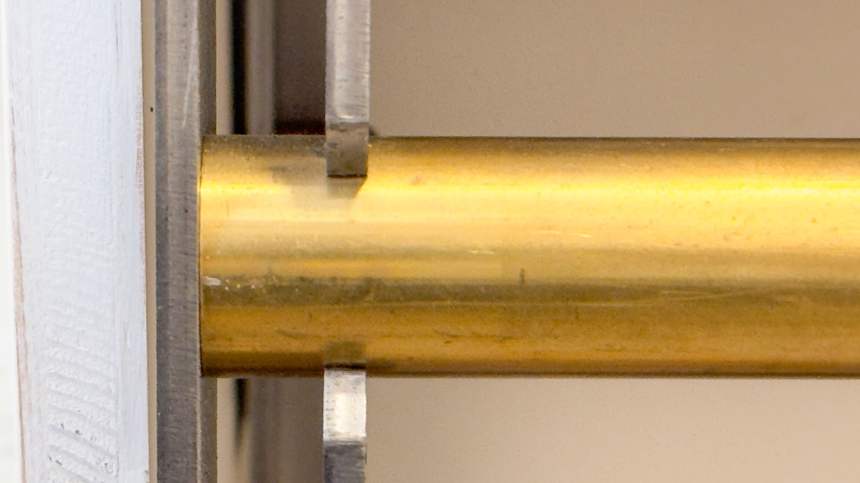A metallic door handle attached to a white door frame.