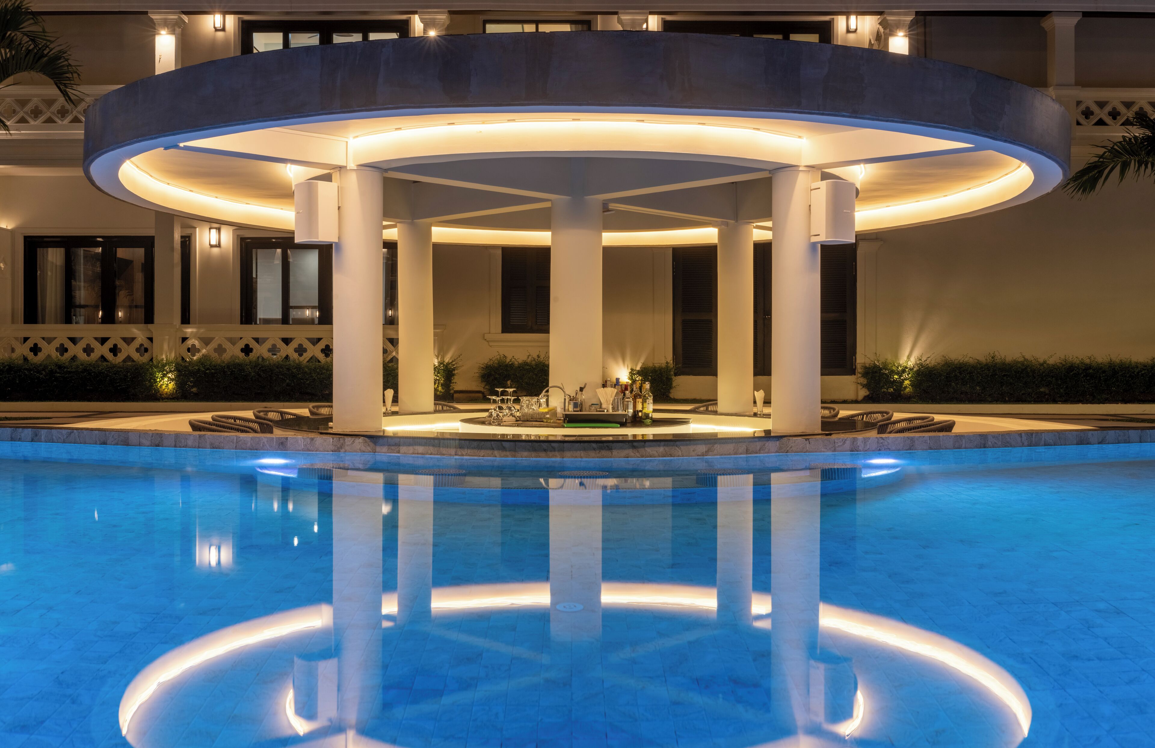 A pool area with a circular structure, columns, and a bar area.