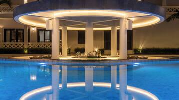 A pool area with a circular structure, columns, and a bar area.