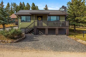 A two-story house with a balcony, a garage, and a gravel driveway. - Mountain Vista (Greer)