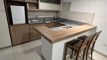Fridge, microwave, stovetop, coffee/tea maker