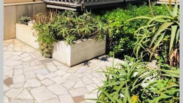 A balcony with a metal railing, surrounded by potted plants and a tiled floor. - SPACIOUS 90 SQM APARTMENT WITH BALCONIES, PRIVATE PARKING - RAFFAELE DE FERRARI (Roma)