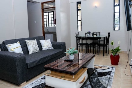 Classic Apartment, City View | Living area | 24-inch Smart TV with digital channels