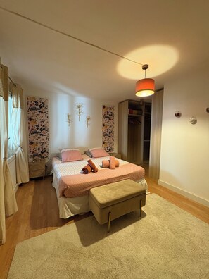 A bedroom with a bed, bedside tables, a bench, a wardrobe, and a hanging light fixture. - Ground-floor apartment, terrace, a 15-minute walk from downtown Arles (Arles)