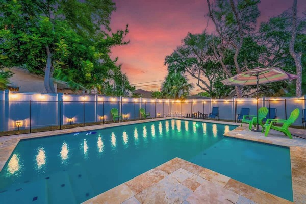 String lights and pool light create a magical atmosphere against the beautiful dawn and dusk sky.