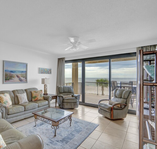 Relax in this stylish living room with a sofa set, recliner chairs, and a glass coffee table.