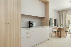 Fridge, stovetop, dishwasher, coffee/tea maker