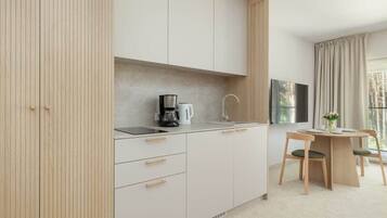 Fridge, stovetop, dishwasher, coffee/tea maker