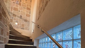 A staircase with stone walls and a glass window. - Heraklia villa sea view pool & jacuzzi (XALKIDIKI)