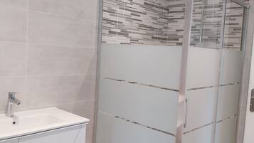 Shower, hair dryer, soap, toilet paper