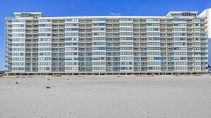 A high-rise hotel with multiple balconies and a sandy beach in the foreground. - On-site Ocean Access: Condo in Myrtle Beach (Myrtle Beach)